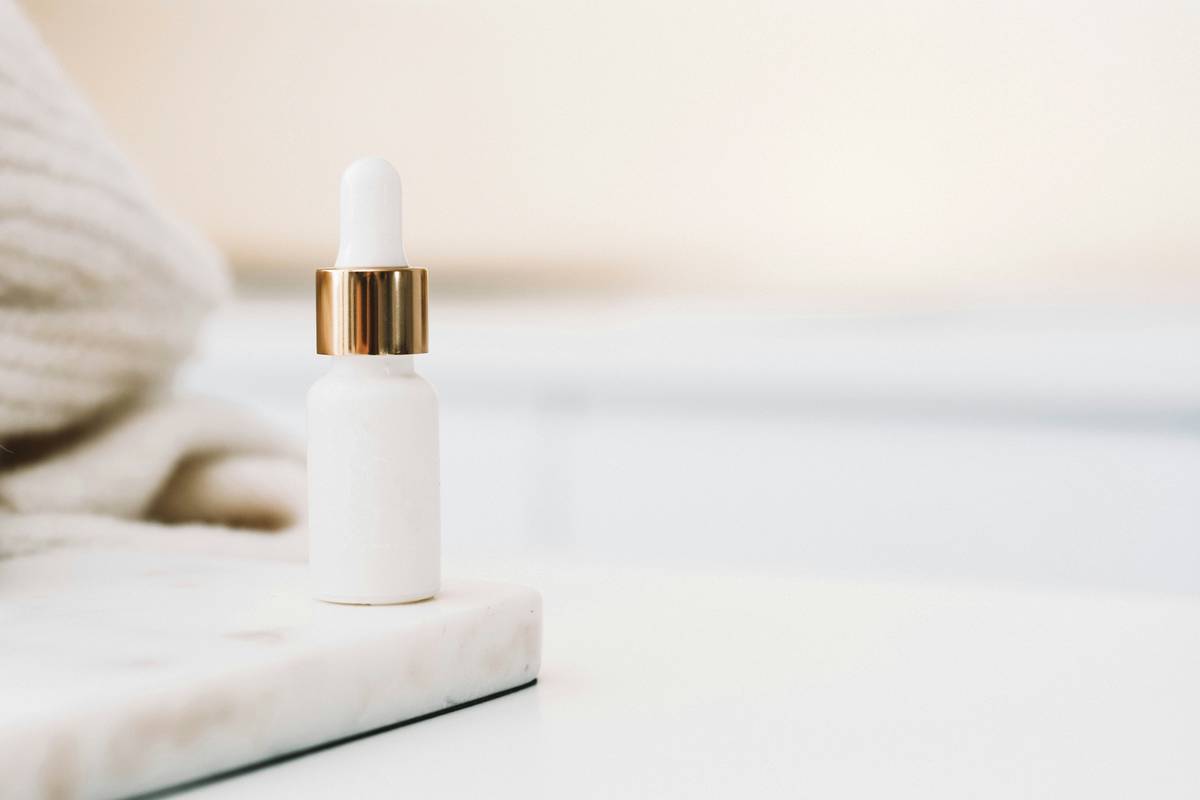 Woman applying subtle makeup product with fingertips for natural finish